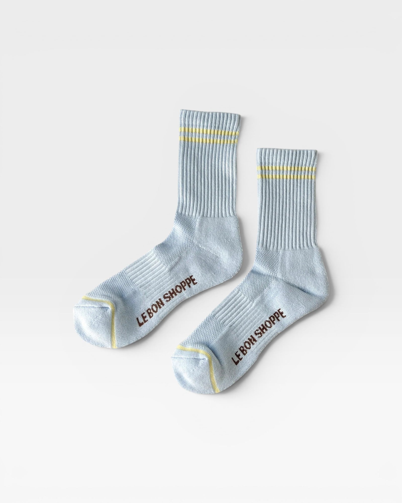 JONES + CO Boyfriend Socks in pastel sky blue with yellow double stripes, ribbed texture, and arch support.