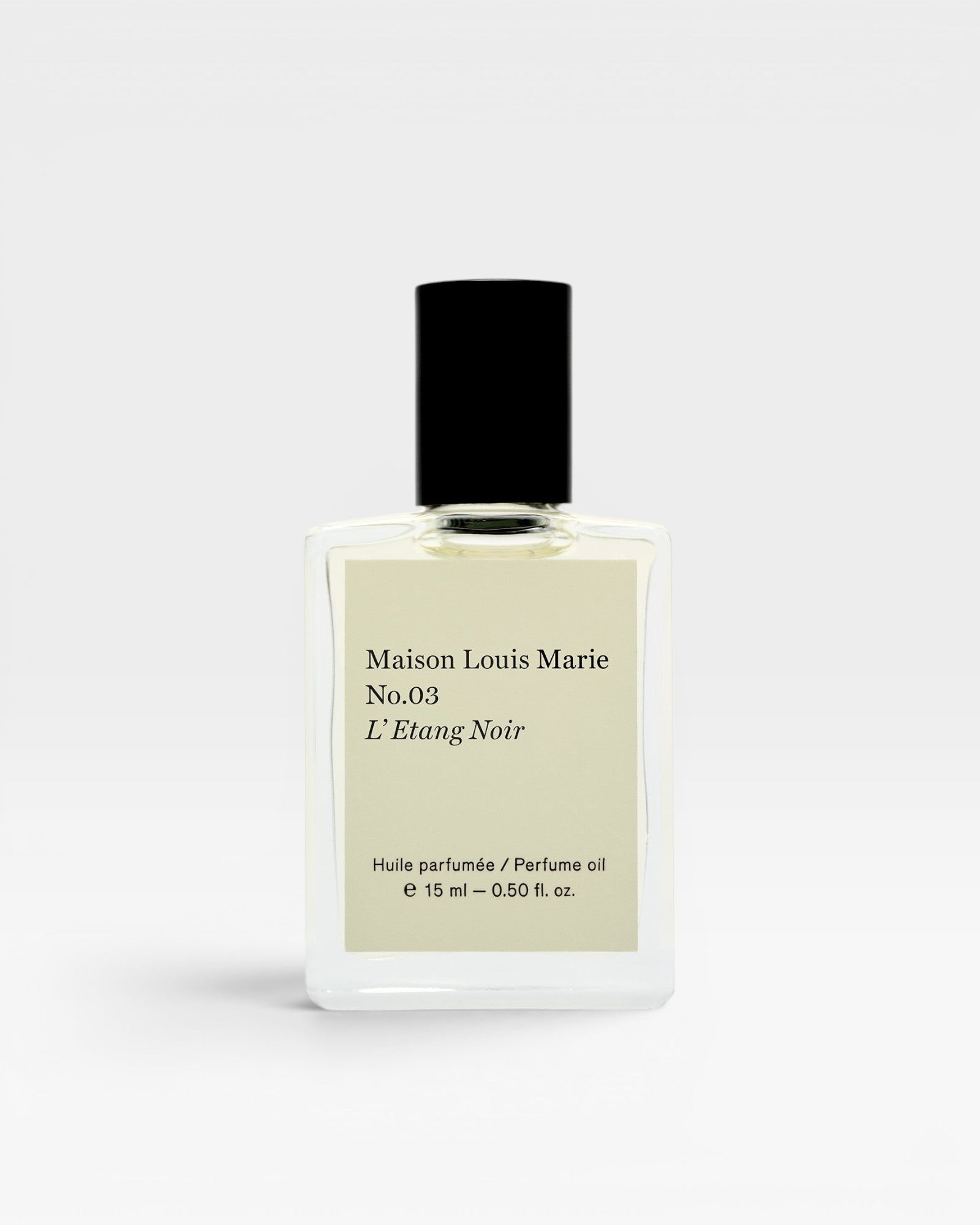 JONES + CO No.03 L'Etang Noir perfume oil in a clear glass bottle with a black cap. The label is cream-colored with black text.