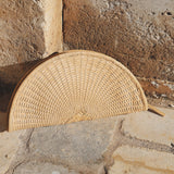 JONES + CO Perla clutch in caramel, a seashell-shaped basketweave leather bag with wrap-around zip.