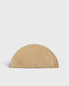 JONES + CO Perla Clutch in caramel, a half-moon shaped bag made from handwoven basketweave leather with a wrap-around zip.