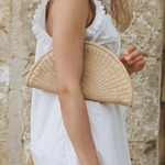 JONES + CO Perla Clutch in caramel, a woven basketweave leather seashell-shaped bag with wrap-around zip.