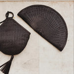 JONES + CO Perla Clutch in espresso basketweave leather, seashell-shaped with tassel detail and zip closure.