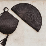 JONES + CO Perla Clutch in espresso basketweave leather, seashell-shaped with tassel detail and zip closure.