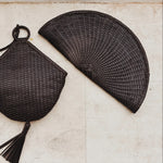 JONES + CO Perla Clutch in espresso basketweave leather, seashell-shaped with tassel detail and zip closure.