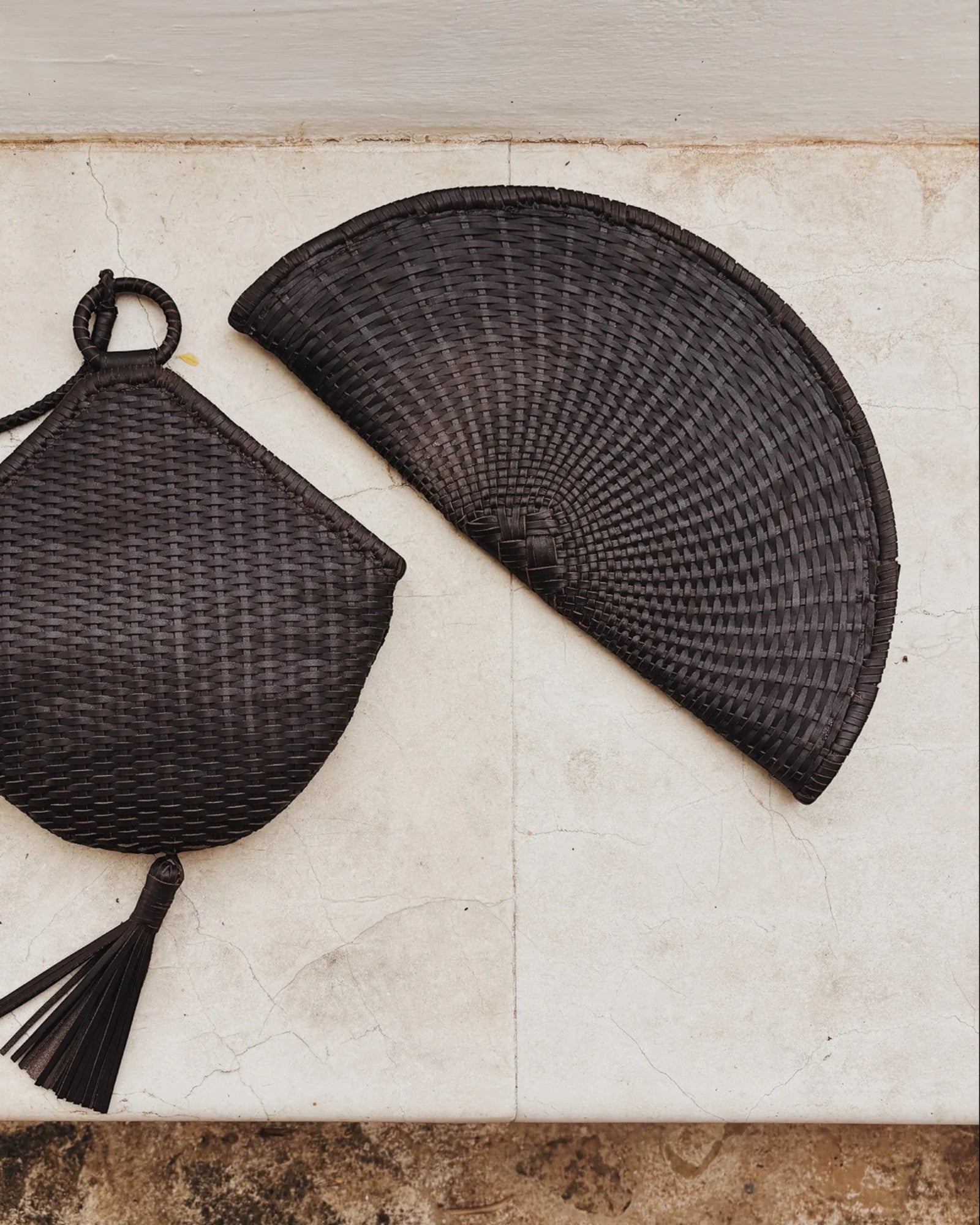 JONES + CO Perla Clutch in espresso basketweave leather, seashell-shaped with tassel detail and zip closure.