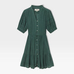 JONES + CO Phoebe short shirtdress in green Muir tartan featuring a ruffled collar, pearl buttons, and pintuck details.