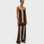 Model wearing JONES + CO Phylis mini slip dress in shiny brown and cream Sintra stripe viscose satin with thin straps