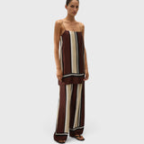 Model wearing JONES + CO Phylis mini slip dress in shiny brown and cream Sintra stripe viscose satin with thin straps