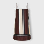 JONES + CO Phylis mini slip dress in shiny viscose satin featuring a brown, cream, and black vertical stripe pattern.