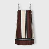JONES + CO Phylis mini slip dress in shiny viscose satin featuring a brown, cream, and black vertical stripe pattern.