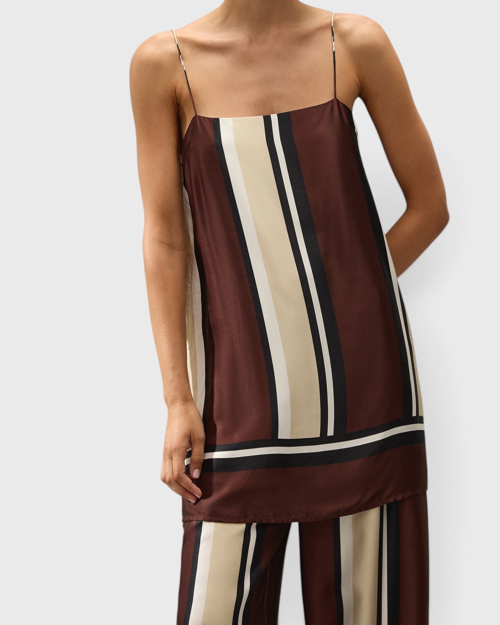 JONES + CO Phylis mini slip dress in shiny viscose satin with brown, cream, and black Sintra stripe pattern.
