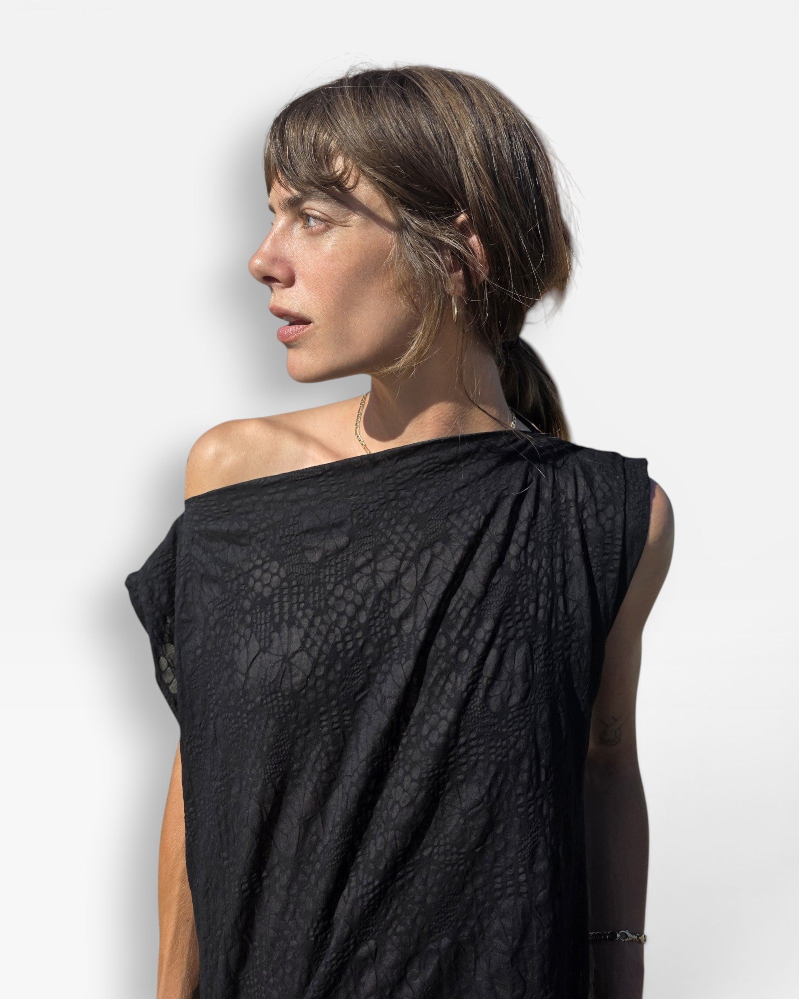 JONES + CO Pinch Shift black dress with embossed floral seersucker texture and versatile off-shoulder neckline.