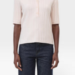 JONES + CO pale pink ribbed short sleeve polo shirt with a smooth collar and cuffs, made from cotton, cashmere, and wool.