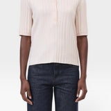 JONES + CO pale pink ribbed short sleeve polo shirt with a smooth collar and cuffs, made from cotton, cashmere, and wool.