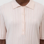 JONES + CO light pink ribbed short sleeve polo shirt with a smooth collar and cuffs.