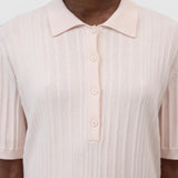 JONES + CO light pink ribbed short sleeve polo shirt with a smooth collar and cuffs.