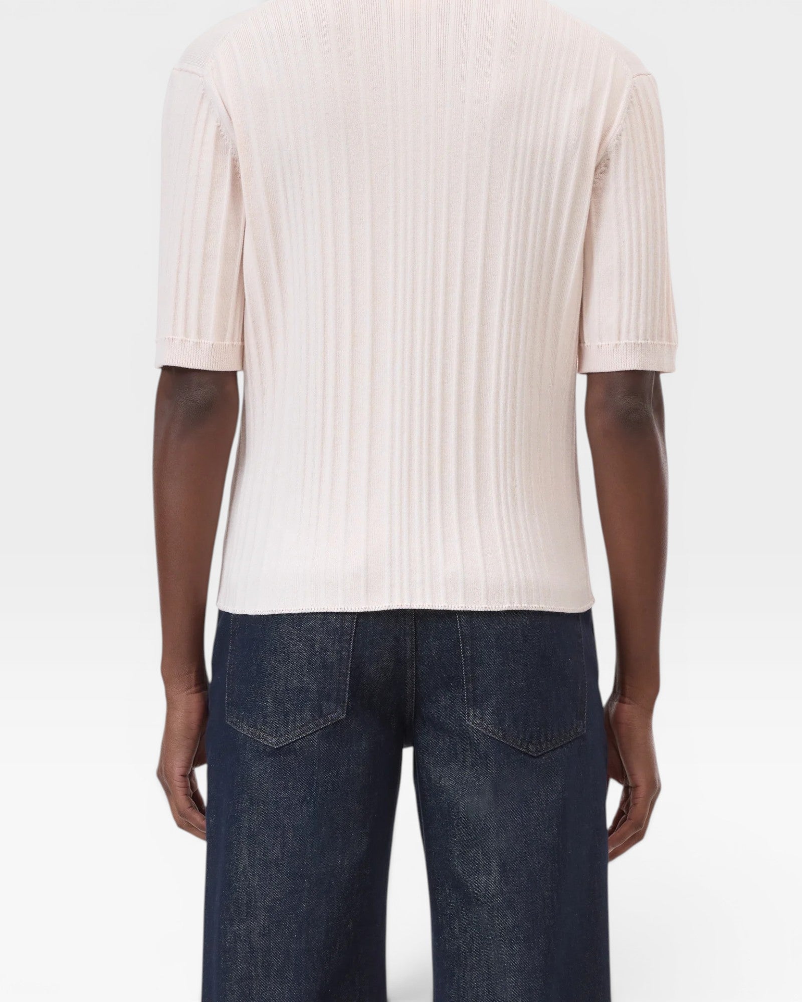 JONES + CO pale pink ribbed short sleeve polo shirt made from cotton yarn with cashmere and wool.