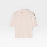 JONES + CO pale pink ribbed short sleeve polo shirt with a smooth knitted collar and cuffs.
