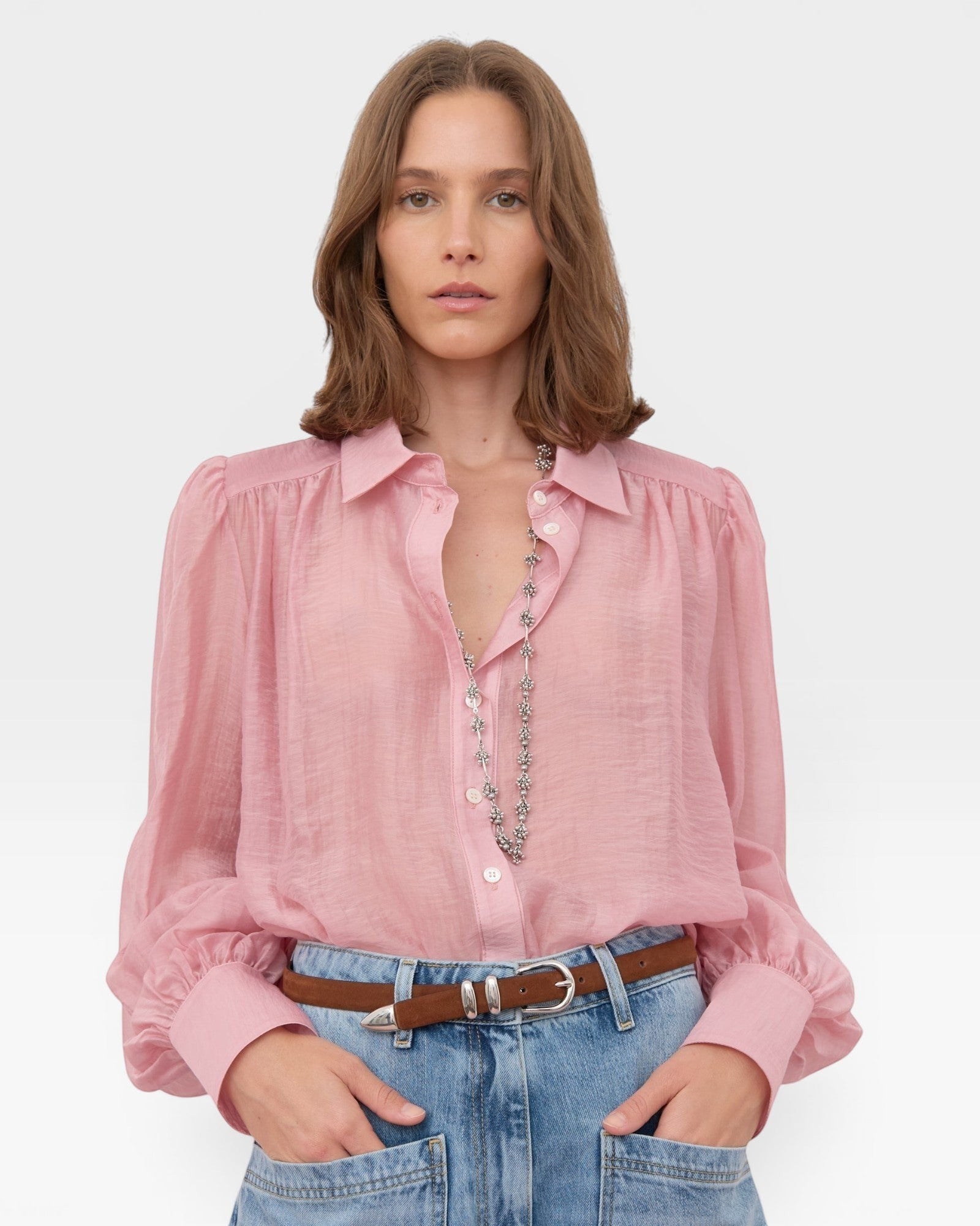 JONES + CO pink sheer crinkled texture button-up shirt with voluminous sleeves and pointed collar.