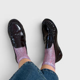 JONES + CO shimmering pink ribbed silk socks worn with dark brown patent leather loafers and blue denim jeans
