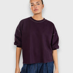 JONES + CO Rachel Comey plum crewneck sweatshirt with drop shoulders, cropped sleeves, and raw edge hemline.
