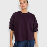 JONES + CO Rachel Comey plum crewneck sweatshirt with drop shoulders, cropped sleeves, and raw edge hemline.