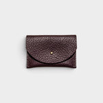 JONES + CO plum leather cardholder with a solid brass fastener and textured finish on a light grey background