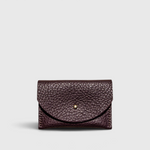 JONES + CO plum leather cardholder with a solid brass fastener and textured finish on a light grey background