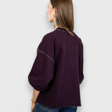 JONES + CO Rachel Comey Fond sweatshirt in plum with drop shoulders and raw edge hem, back view on a model.