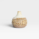 JONES + CO Stone Fired Prambanan Vase with a textured, carved pattern in earthy tones and a cream glaze.
