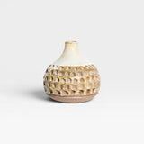 JONES + CO Stone Fired Prambanan Vase with a textured, carved pattern in earthy tones and a cream glaze.