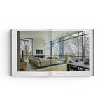 JONES + CO Private Aspen book open to a page showing a modern living room with floor-to-ceiling windows and mountain views