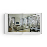 JONES + CO Private Aspen book open to a page showing a modern living room with floor-to-ceiling windows and mountain views