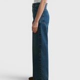 JONES + CO Puerto high-rise straight leg jeans in aged indigo cotton denim, side profile view on a model.