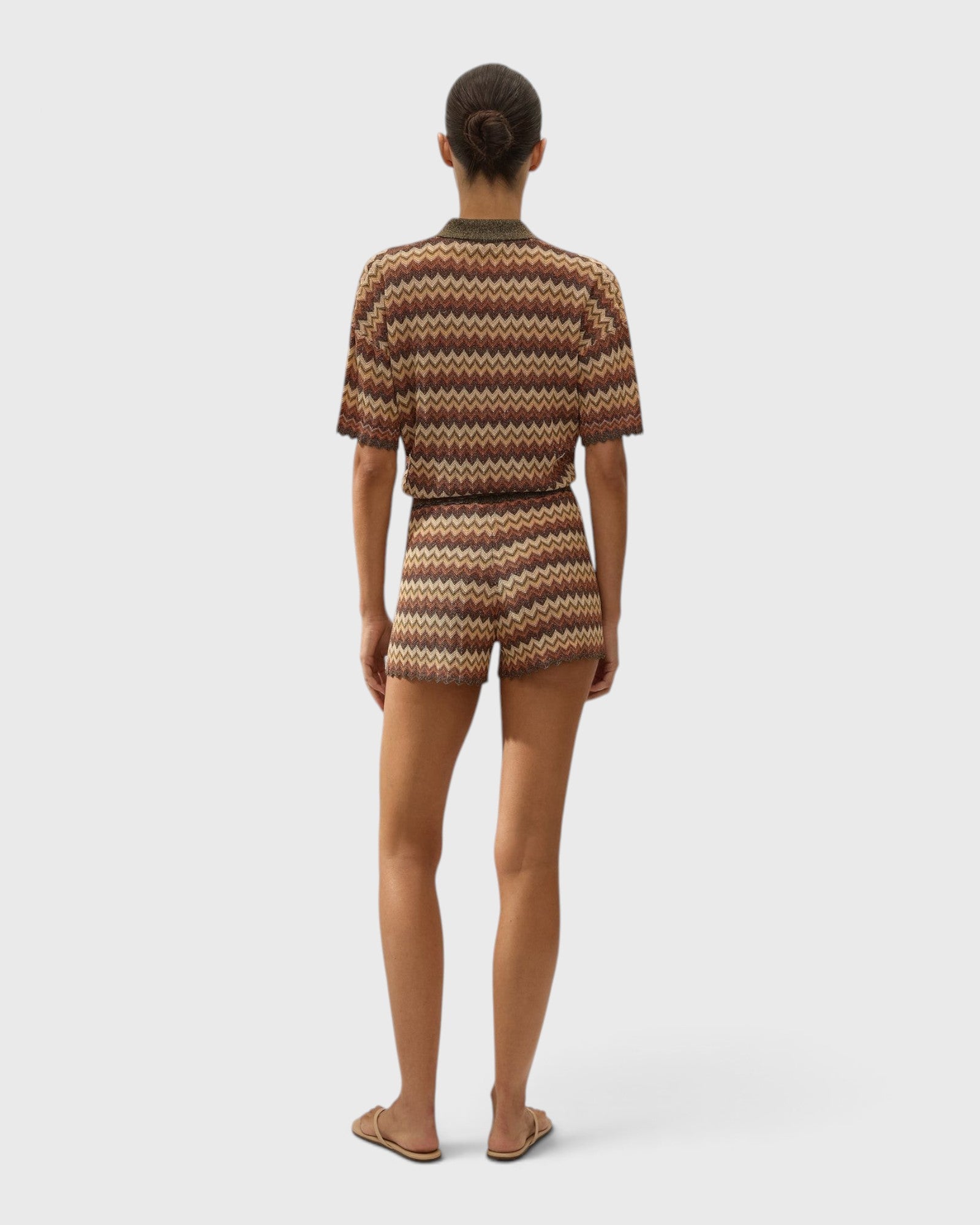 JONES + CO Raya high-rise knit shorts in Lais multi-color stripe with a ribbed waistband and zig zag hem, back view.