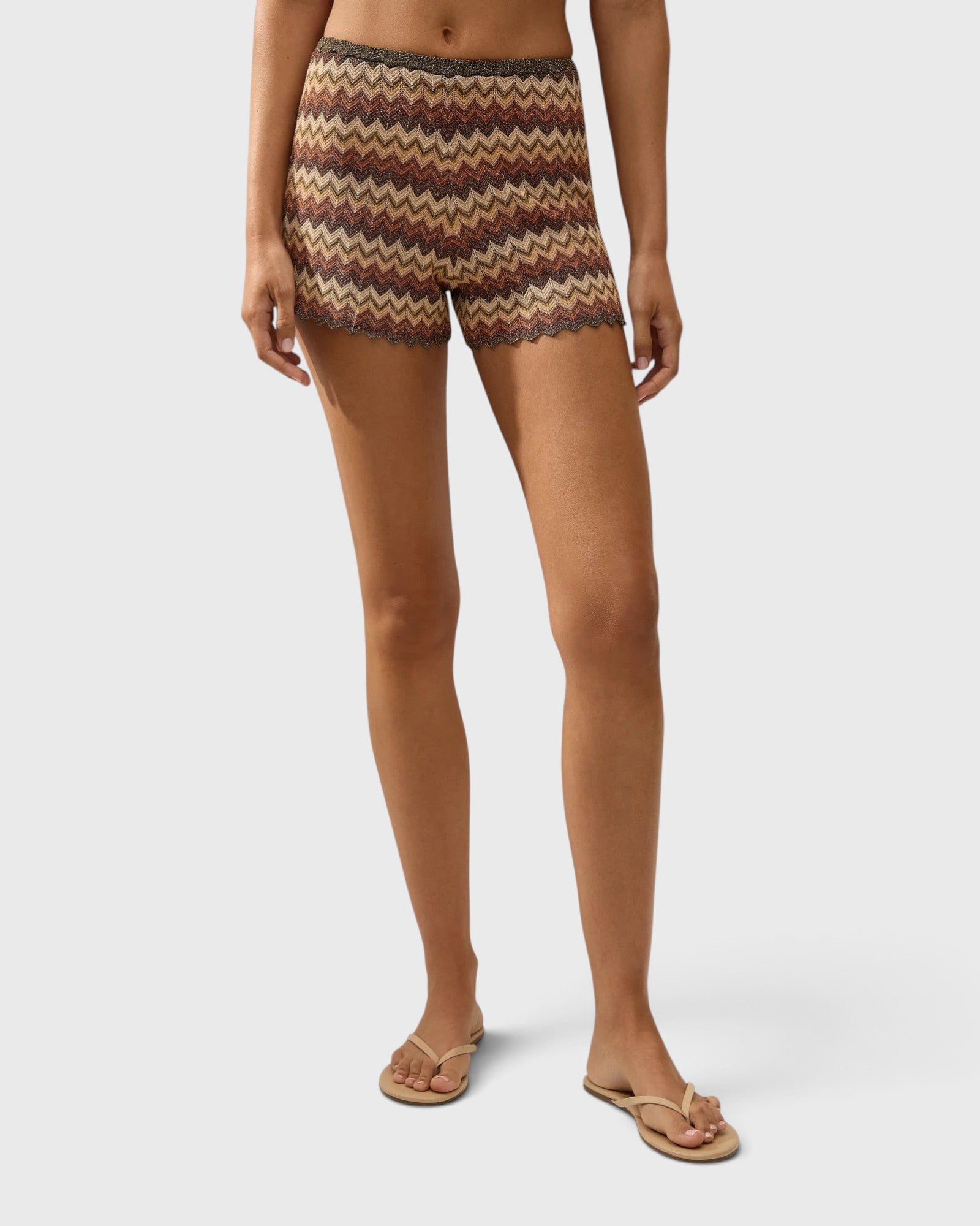 JONES + CO Raya high-rise knit mini shorts in a multi-color zig zag stripe pattern with a scalloped hem