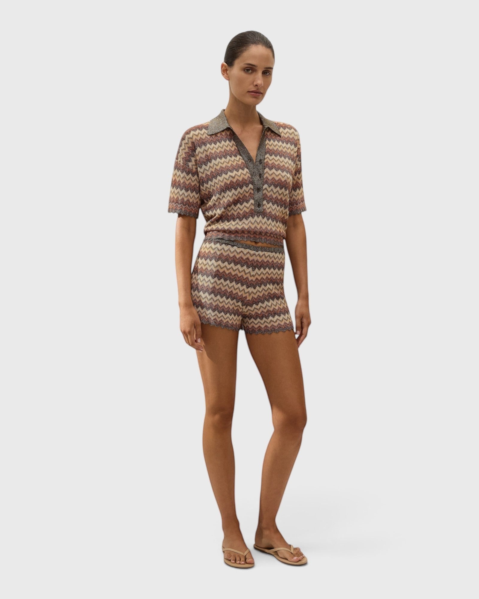 Model wearing JONES + CO Raya polo top in Lais stripe crochet knit with collared neckline and short sleeves.