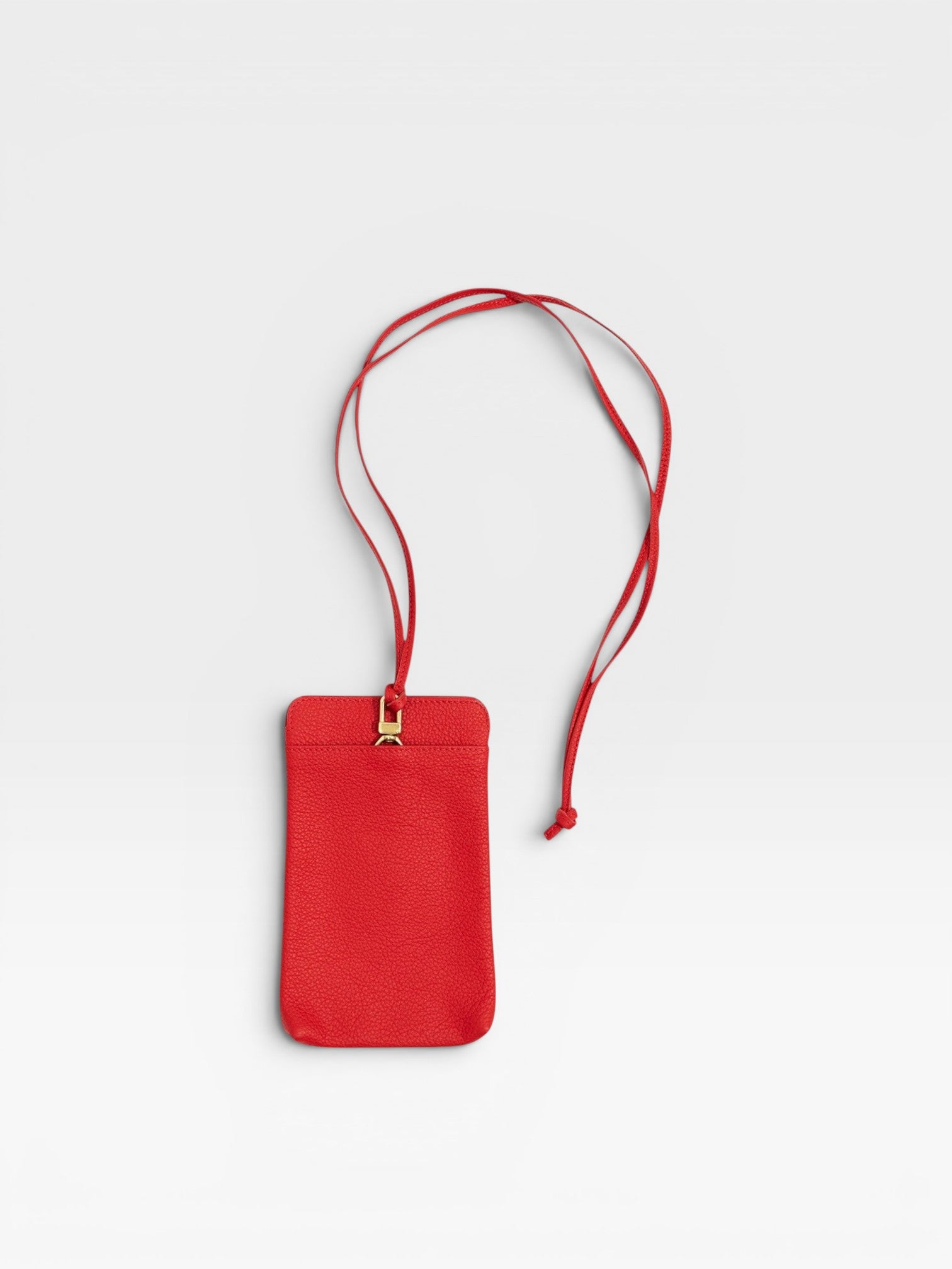 JONES + CO red pebble leather Paris Phone Purse crossbody bag with gold hardware and adjustable strap.