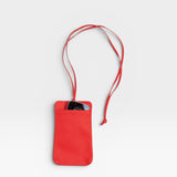 JONES + CO red pebble leather Paris Phone Purse crossbody bag with a phone inside.
