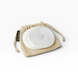 JONES + CO reusable white cotton rounds in a mesh bag for makeup removal and cleansing.