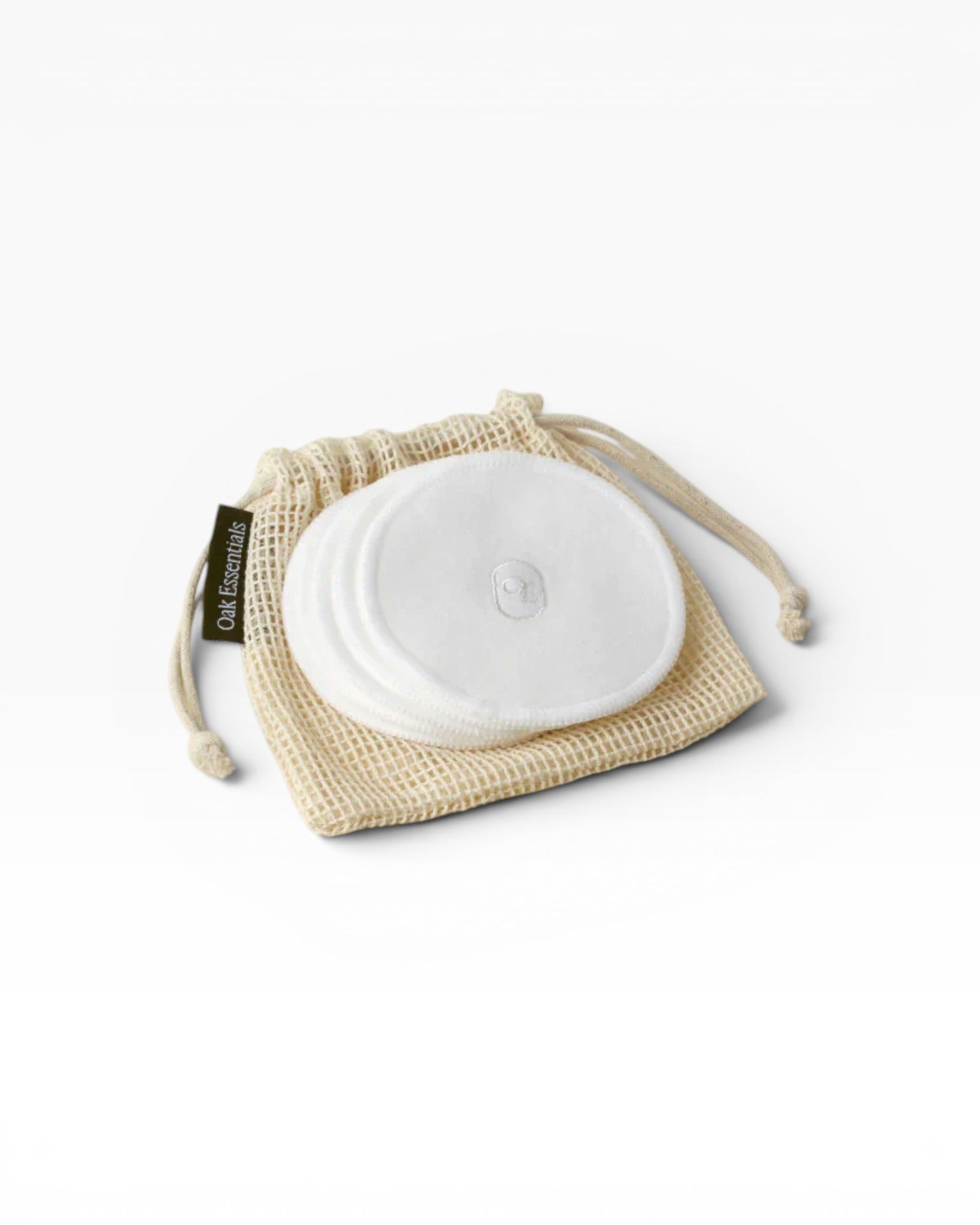 JONES + CO reusable white cotton rounds in a mesh bag for makeup removal and cleansing.