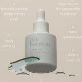 JONES + CO Ritual Oil, a lightweight Blue Tansy face oil in a white dropper bottle, shown with spilled oil.
