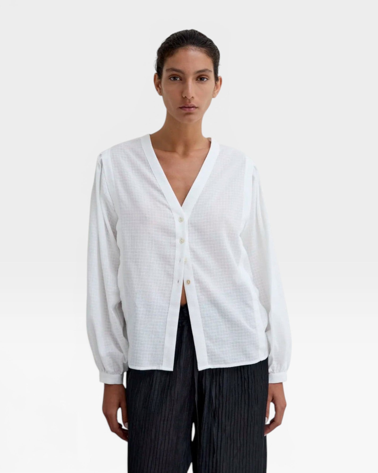 JONES + CO Rodas Blouse: White organic cotton voile with tone-on-tone check, V-neck, long gathered sleeves, mother-of-pearl buttons.