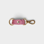 JONES + CO rose hair on hide keychain with solid brass keyring and clip on a light grey background