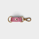 JONES + CO rose hair on hide keychain with solid brass keyring and clip on a light grey background
