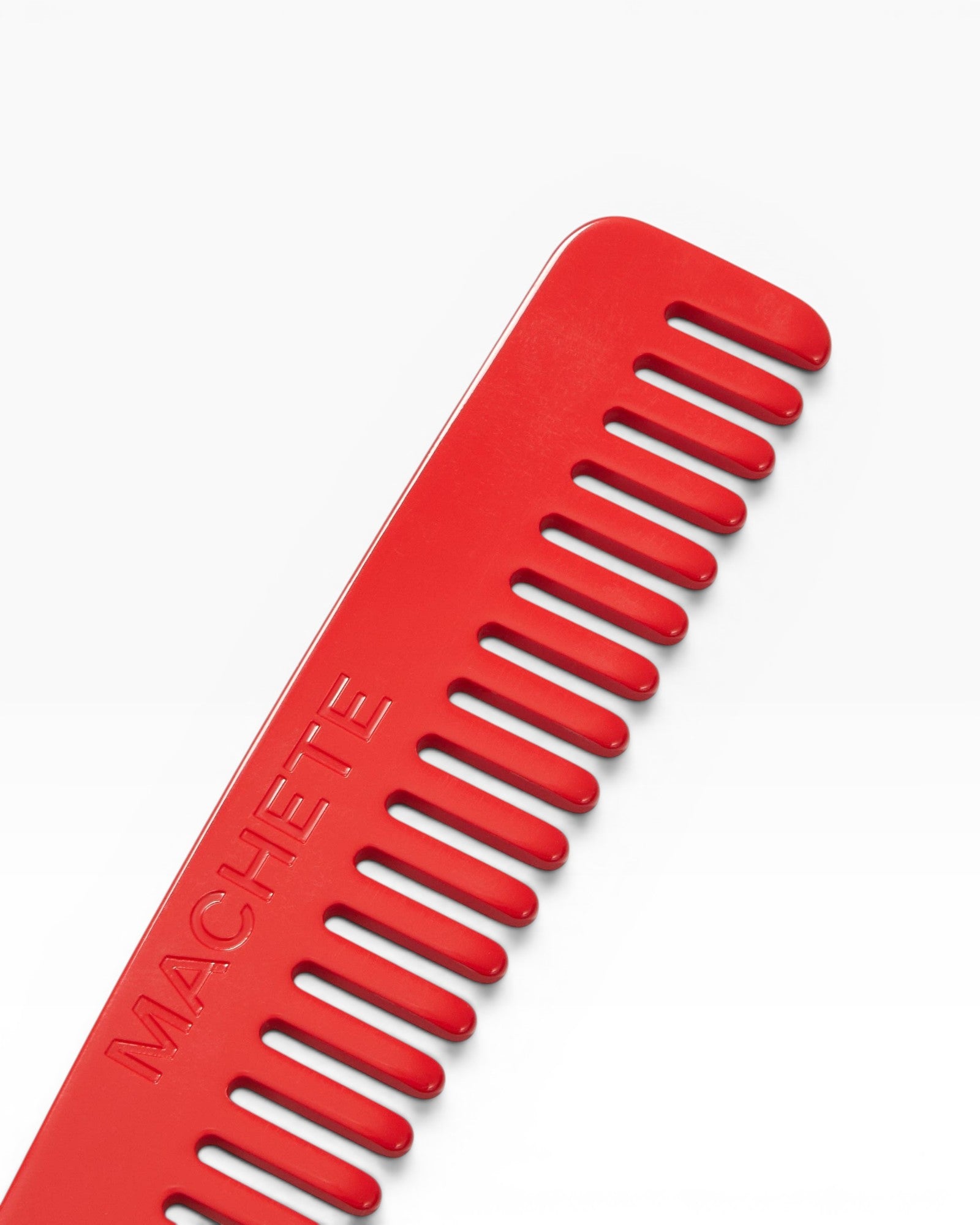 JONES + CO No. 3 Comb in Ruby red, a compact wide-tooth travel comb handcrafted from Italian bio-acetate.