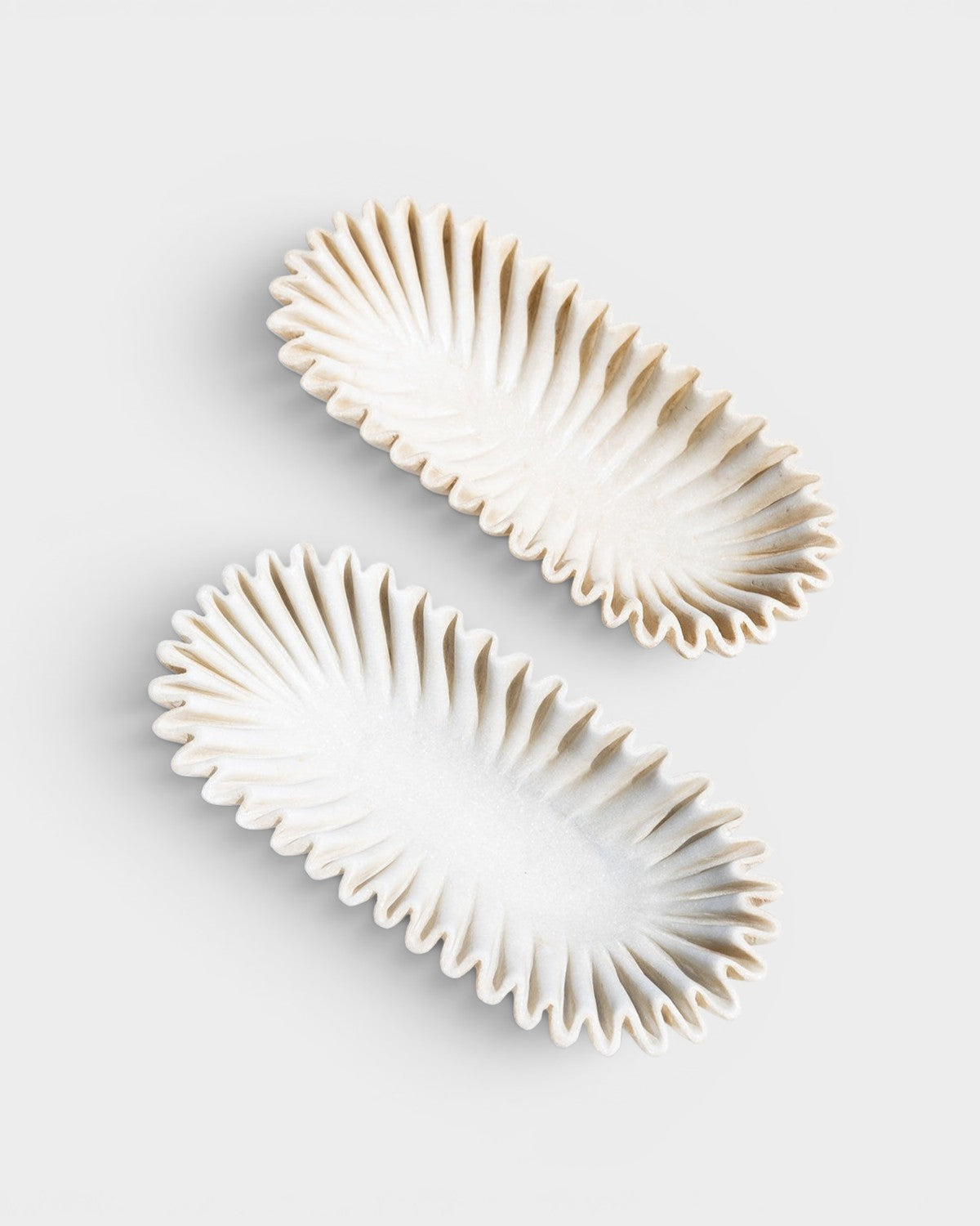 JONES + CO Ruffle Marble Oval Bowl, hand-carved natural marble with scalloped edges and organic silhouette. White.