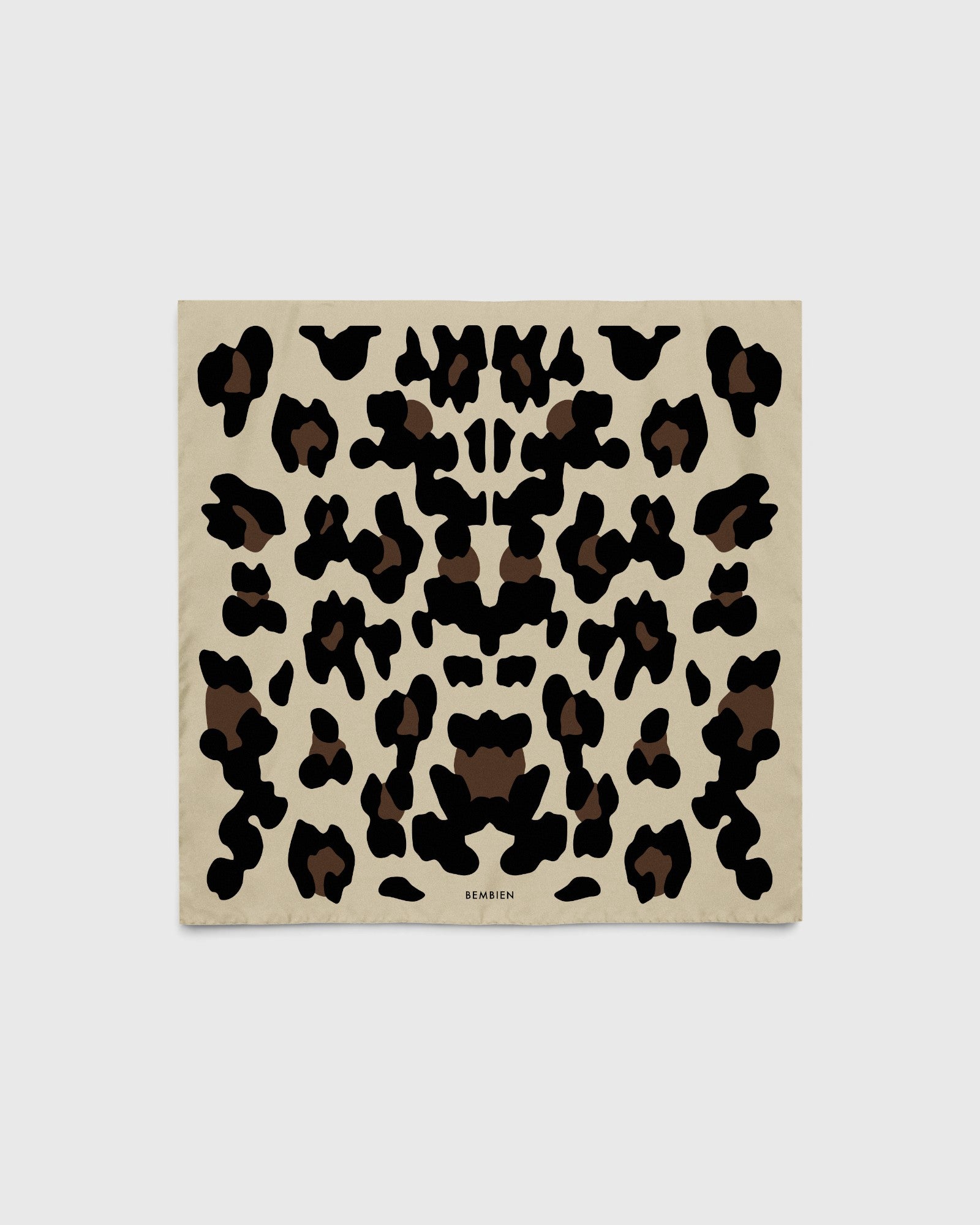 JONES + CO Sahara Scarf in sand featuring a black and brown leopard print pattern on matte silk crêpe de Chine.