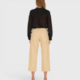 JONES + CO Alex midrise utility cotton jeans in sand with patch pockets, back view on a model wearing a black blouse.
