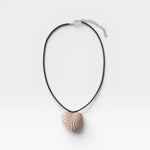 JONES + CO sculptural shell-inspired heart pendant necklace on black leather cord. Acrylic material.